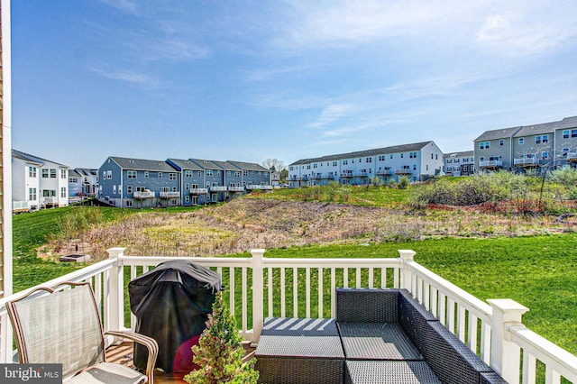 view of wooden balcony with a deck, grilling area, and a residential view