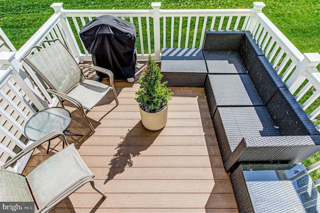 wooden deck featuring a grill