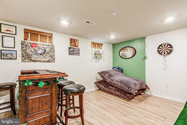 bedroom with wood finished floors, recessed lighting, visible vents, and baseboards