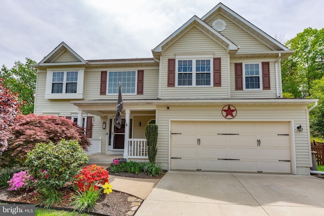 view of front of house with covered porch, a garage, and concrete driveway