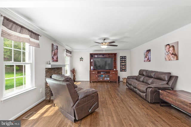 living room with visible vents, ornamental molding, and plenty of natural light