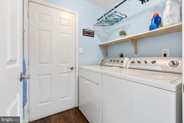 clothes washing area with dark wood-style flooring, laundry area, and washing machine and dryer