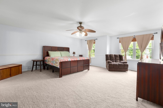 carpeted bedroom featuring ceiling fan and baseboards