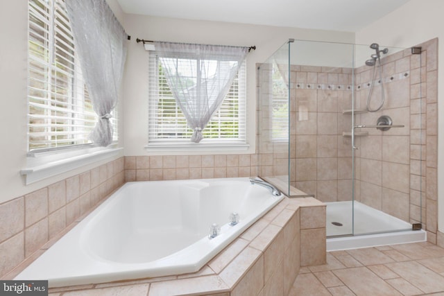 full bathroom with tile patterned floors, a garden tub, and a stall shower