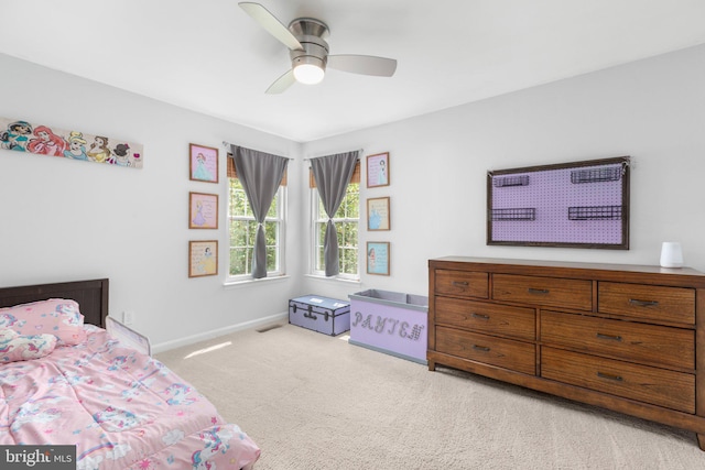 carpeted bedroom with visible vents, ceiling fan, and baseboards