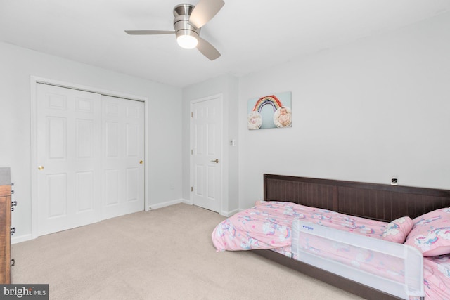 bedroom with baseboards, ceiling fan, a closet, and carpet flooring