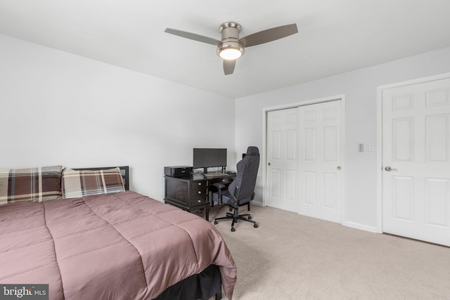 carpeted bedroom featuring a ceiling fan, baseboards, and a closet