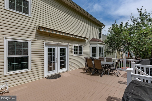wooden terrace featuring outdoor dining space and french doors