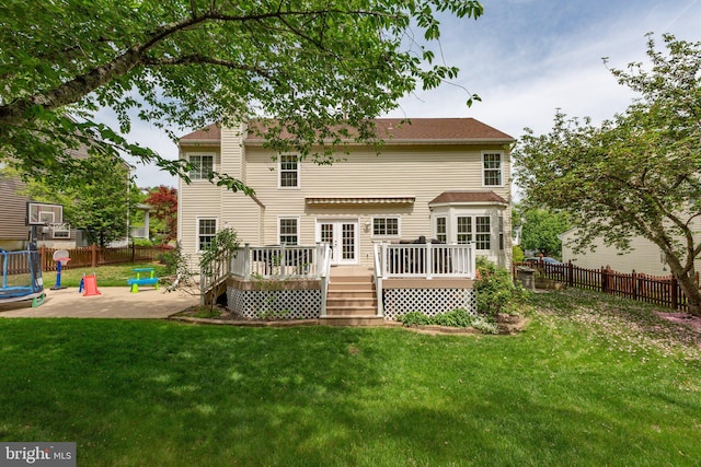 back of house with a patio, a fenced backyard, a deck, and a lawn