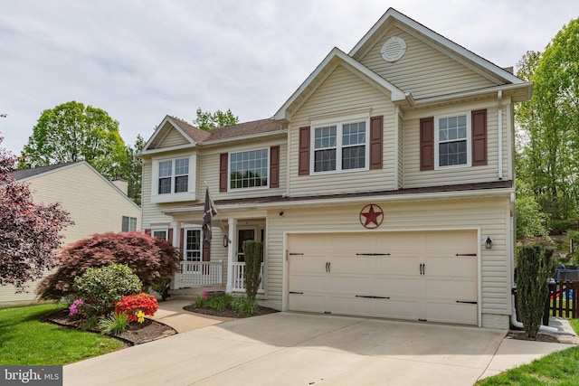view of front facade with a porch, concrete driveway, and an attached garage