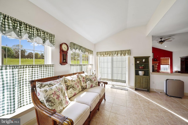 tiled living room featuring baseboards, a ceiling fan, and lofted ceiling