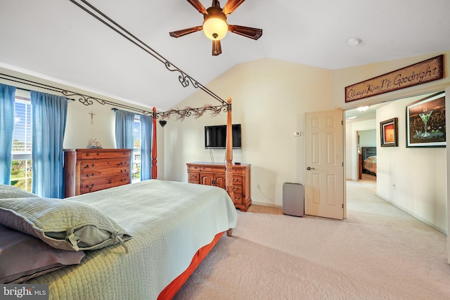 bedroom with carpet floors, baseboards, lofted ceiling, and multiple windows