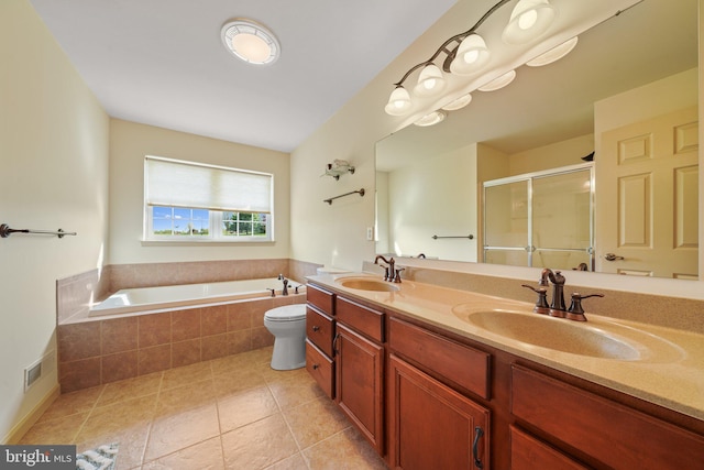 full bathroom with a garden tub, a sink, a stall shower, and tile patterned floors