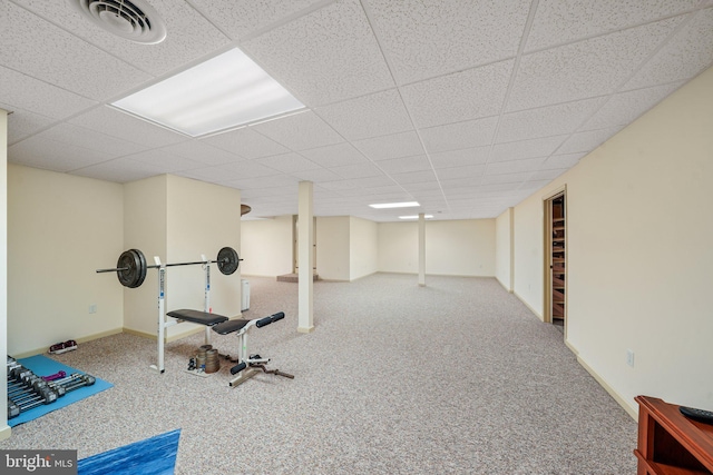 workout area with baseboards, carpet, a paneled ceiling, and visible vents