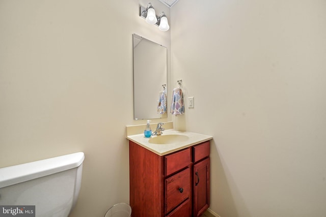 half bath with vanity and toilet