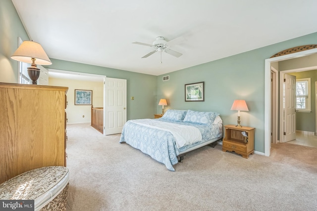 carpeted bedroom with a ceiling fan and baseboards