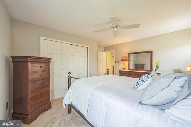 bedroom featuring a closet, ceiling fan, and light carpet