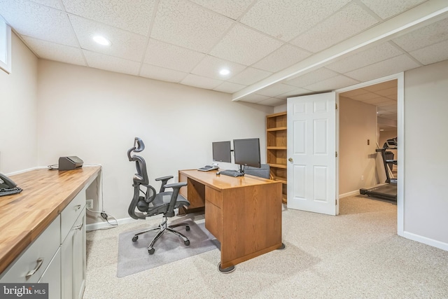 home office with recessed lighting, a drop ceiling, light colored carpet, and baseboards