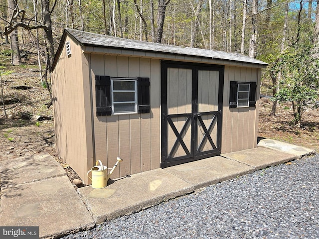 view of shed with a forest view