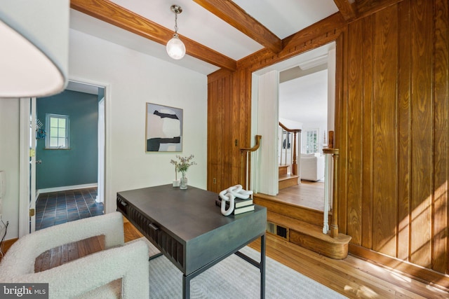 office featuring baseboards, wood finished floors, and beamed ceiling