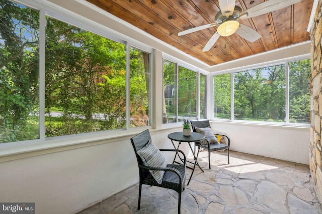 sunroom featuring a ceiling fan