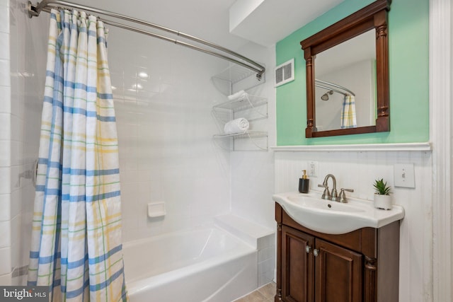 full bath featuring vanity, visible vents, and shower / tub combo
