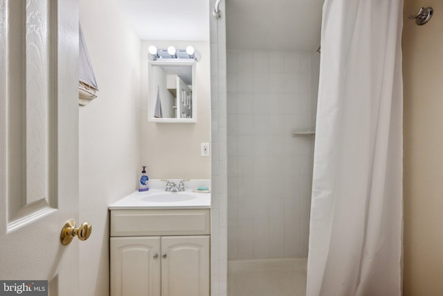 full bathroom with vanity and a tile shower