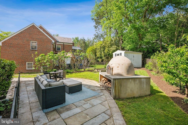 view of patio featuring a fenced backyard, a shed, an outbuilding, and outdoor dining space