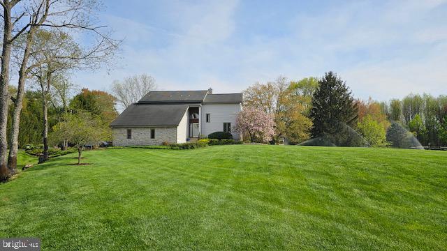 rear view of house featuring a yard