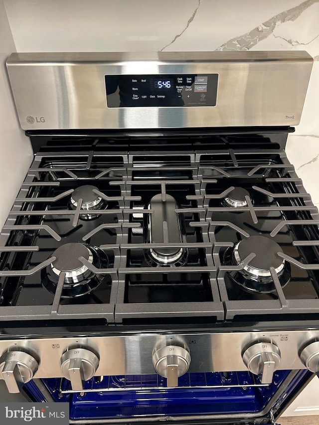 detailed view of stainless steel range with gas stovetop