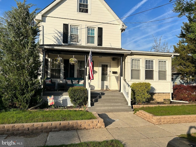 traditional-style home featuring covered porch