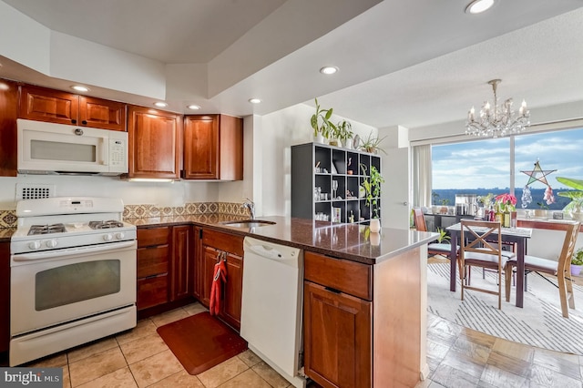 4515 Willard Ave Unit 1710S, Chevy Chase, MD 20815 - kitchen with an inviting chandelier, a peninsula, white appliances, recessed lighting, and a sink