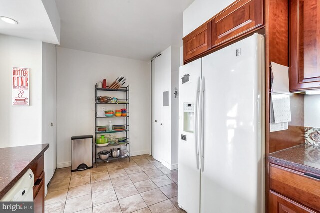 4515 Willard Ave Unit 1710S, Chevy Chase, MD 20815 - kitchen featuring light tile patterned floors, baseboards, and white fridge with ice dispenser