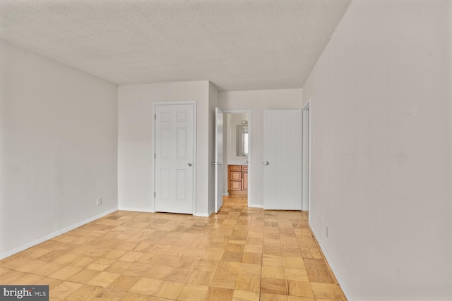 4515 Willard Ave Unit 1710S, Chevy Chase, MD 20815 - unfurnished bedroom featuring baseboards and a textured ceiling