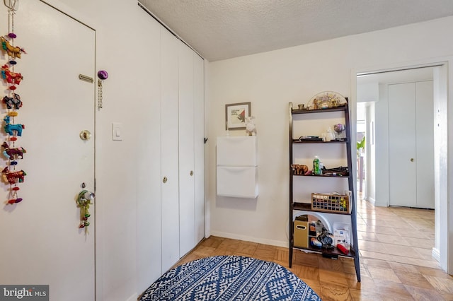4515 Willard Ave Unit 1710S, Chevy Chase, MD 20815 - hallway featuring baseboards and a textured ceiling