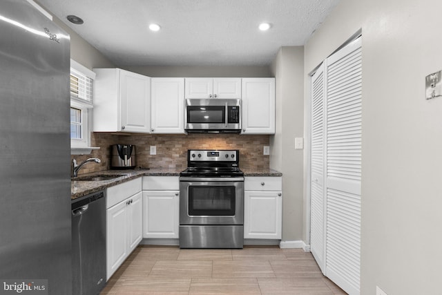 10205 Queen Elizabeth Dr, Upper Marlboro, MD 20772 - kitchen featuring white cabinetry, a sink, appliances with stainless steel finishes, and tasteful backsplash