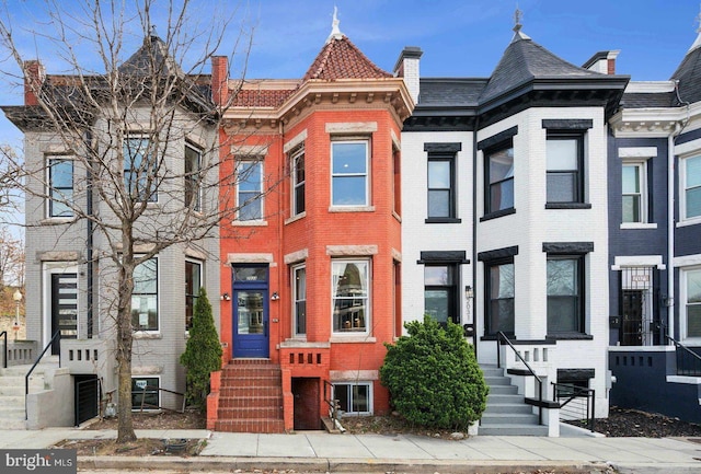 view of property featuring entry steps and brick siding