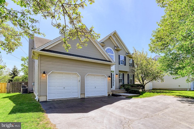 view of front of house featuring fence, a front yard, central AC unit, an attached garage, and driveway