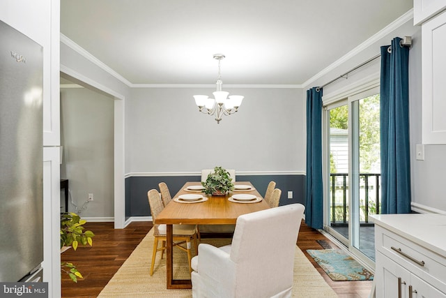 dining room featuring ornamental molding, a notable chandelier, baseboards, and dark wood finished floors