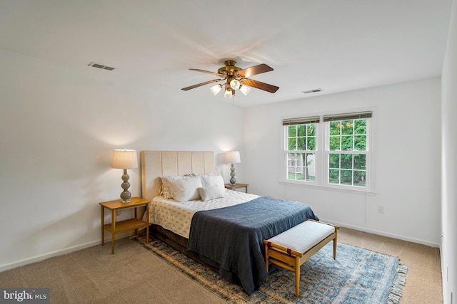 bedroom featuring carpet flooring, baseboards, a ceiling fan, and visible vents