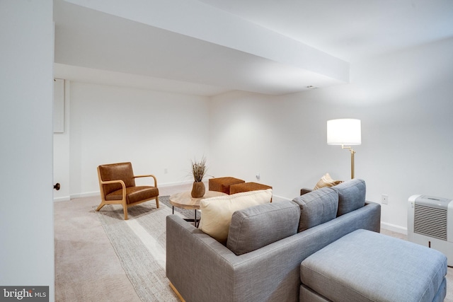 living room featuring light carpet and baseboards