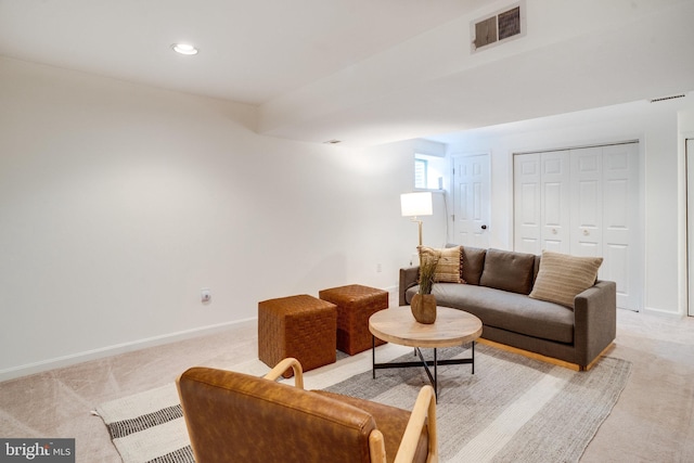 living area with light carpet, baseboards, visible vents, and recessed lighting