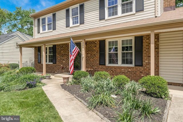 view of front facade with a porch and brick siding