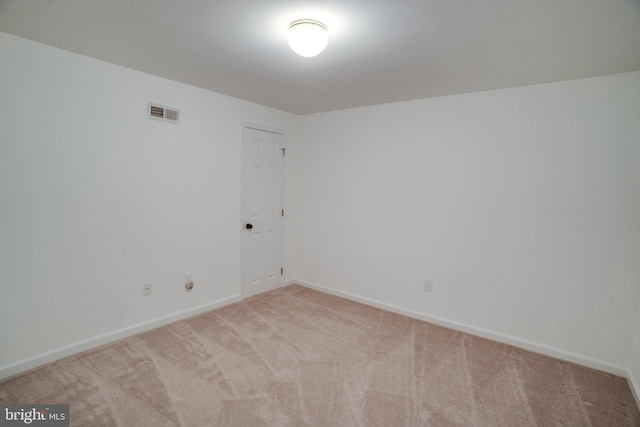 spare room featuring carpet floors, baseboards, and visible vents