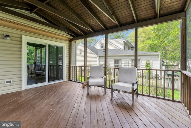 sunroom featuring beam ceiling