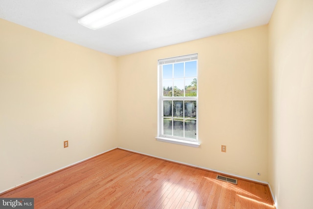 empty room with visible vents and wood finished floors