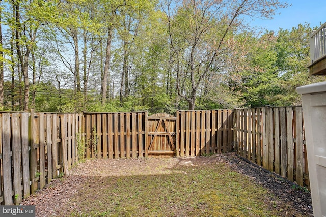 view of yard featuring a gate and a fenced backyard