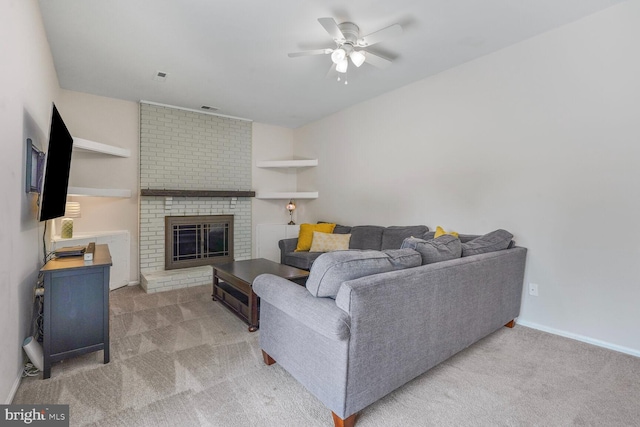 living area with carpet flooring, ceiling fan, a fireplace, baseboards, and visible vents