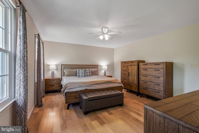 bedroom with ceiling fan and light wood-style flooring