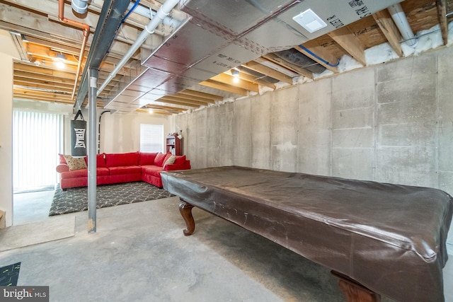 rec room featuring billiards and unfinished concrete flooring